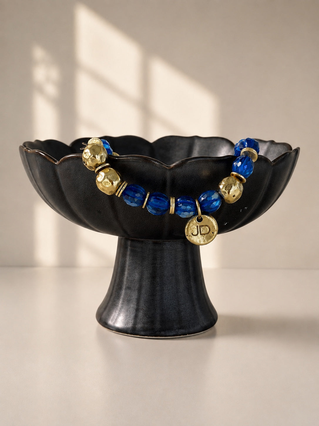Gilded Cobalt bracelet with blue faceted glass and gold-tone cast brass beads.