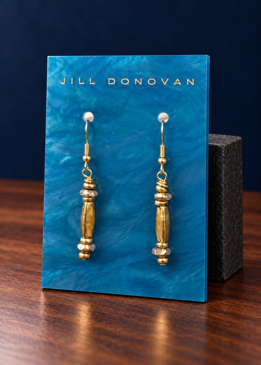 Golden Column Drop Earrings on a Jill Donovan lucite card