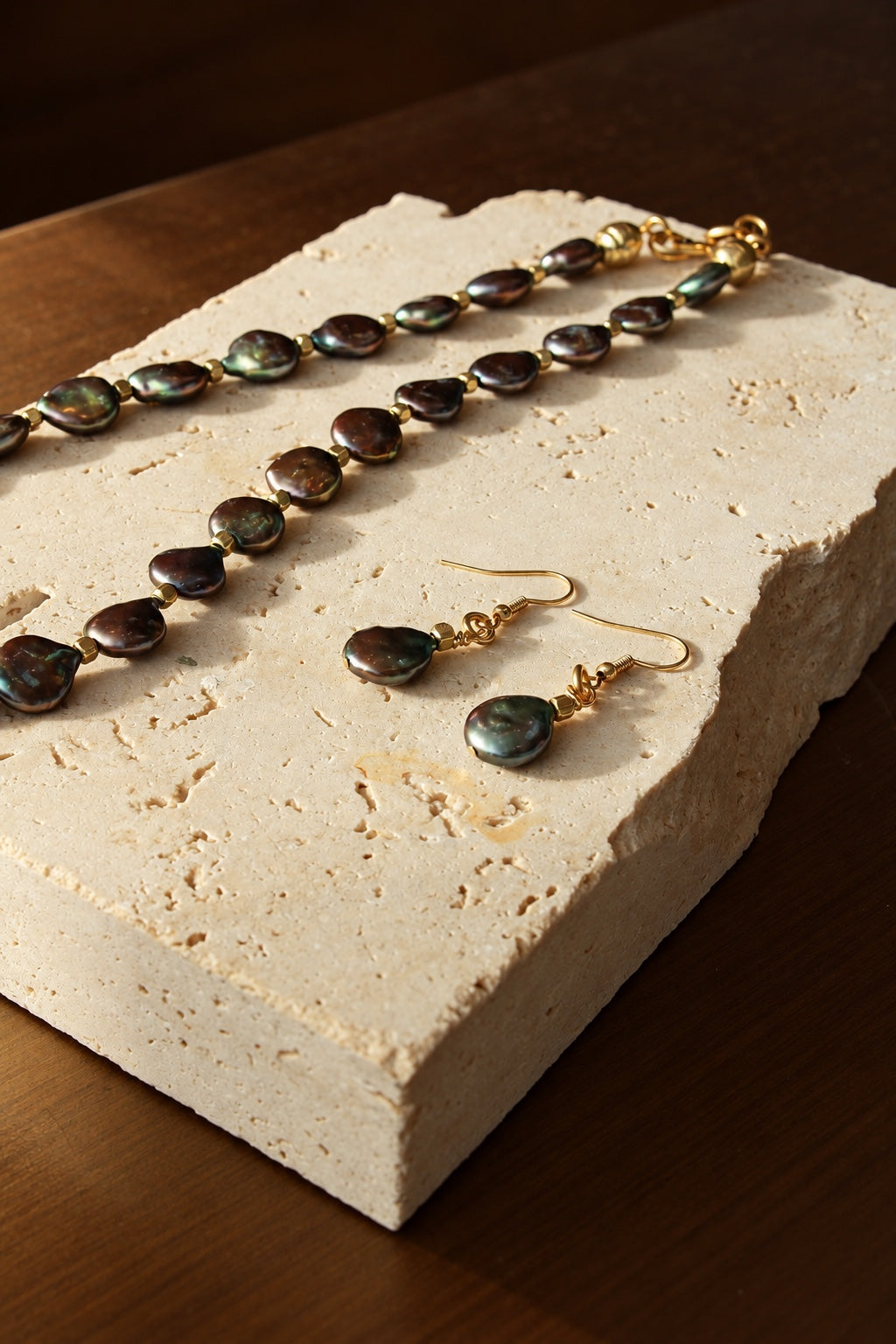 Close view of dark freshwater pearls and matching drop earrings