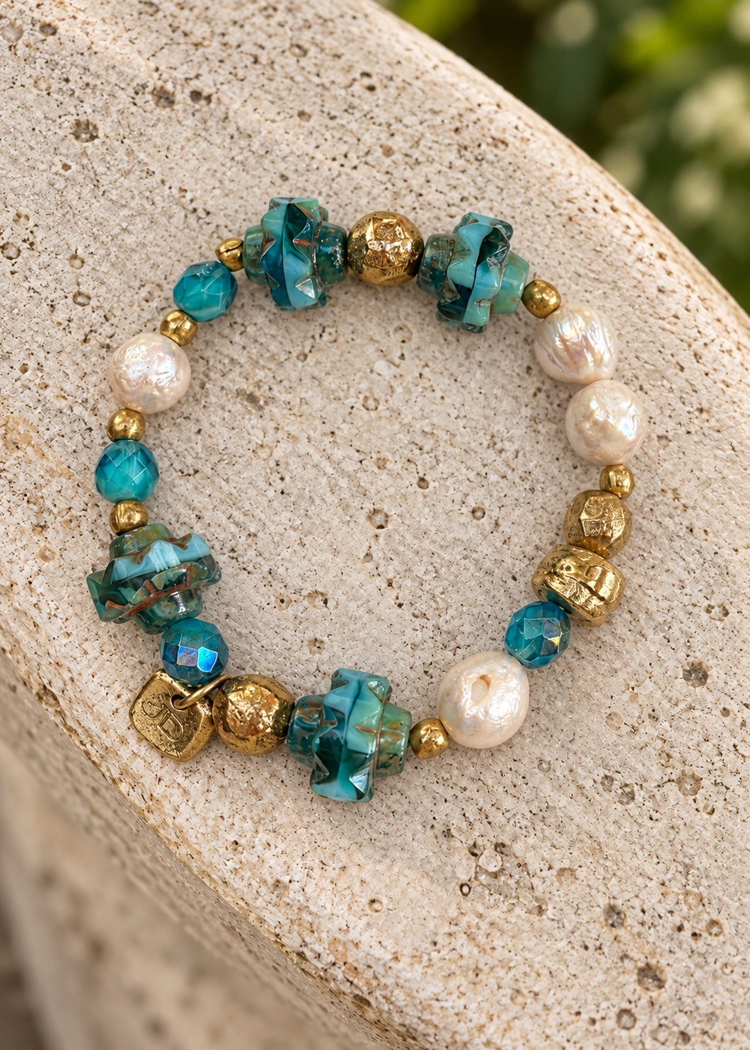 Crown and Clover bracelet on light stone