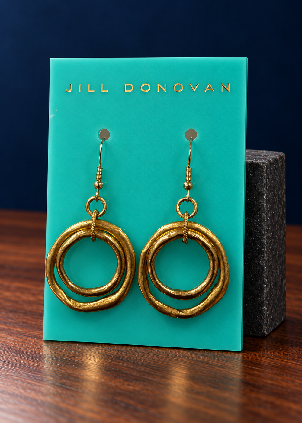 Golden Double Circle Earrings on a Jill Donovan lucite card