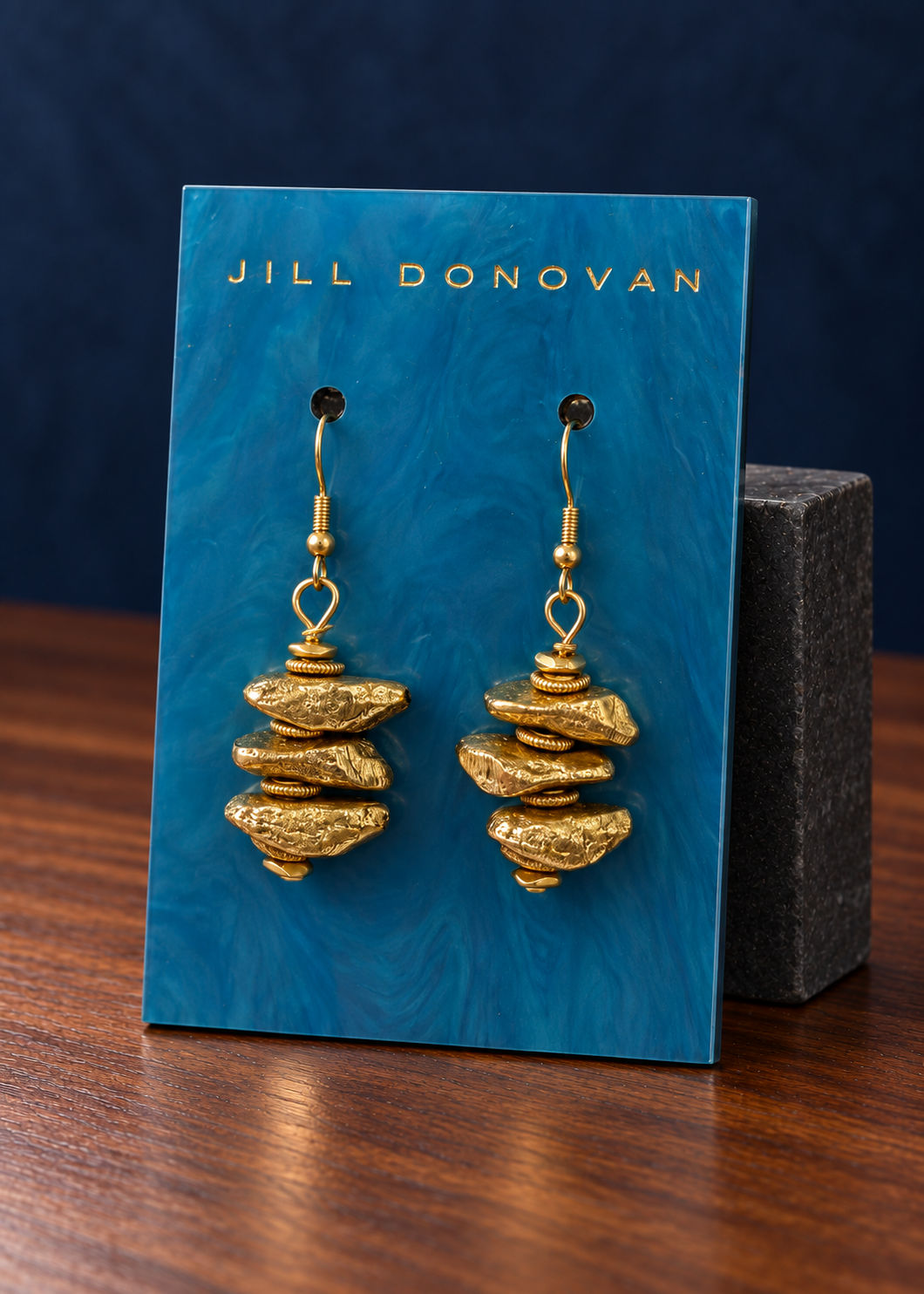 Golden Stacked Earrings displayed on a lucite card