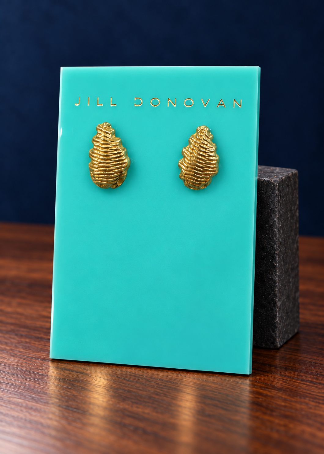 Golden Ridged Stud Earrings on a Jill Donovan lucite card