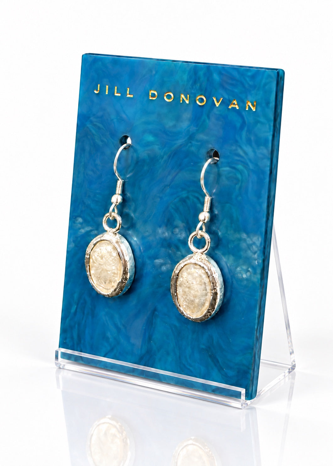 Pearlized Oval Earrings on a blue Jill Donovan display