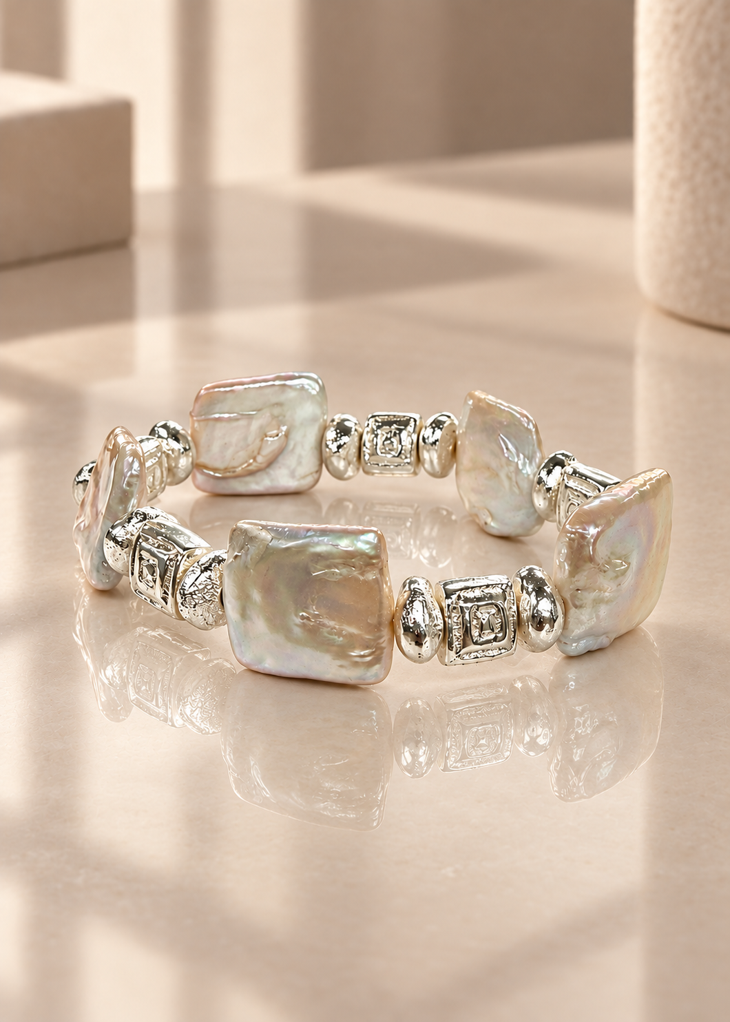 Poetic Pearl - Silver Delight on reflective ivory surface