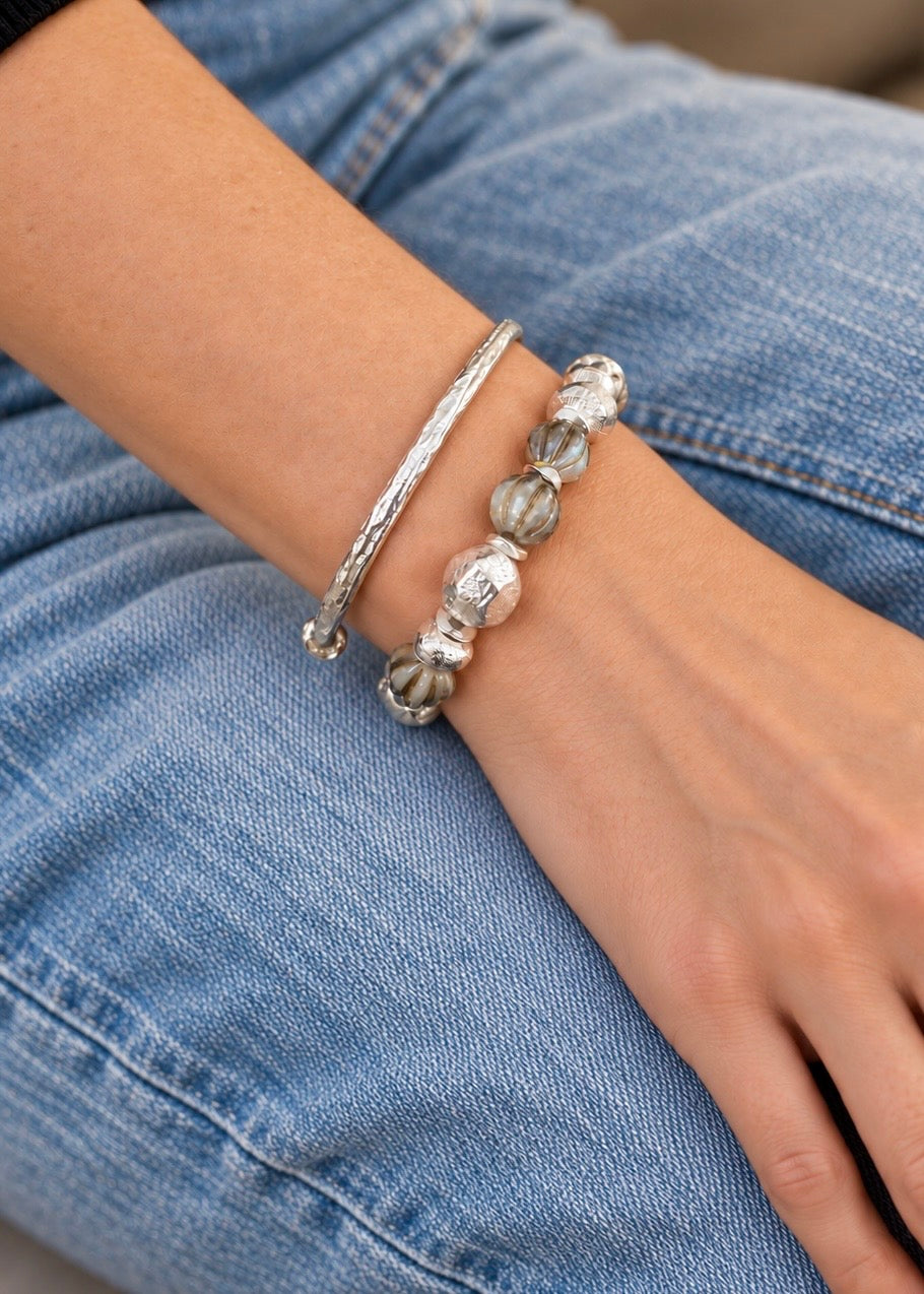 Silver Saturdays bracelet worn with the included silver cuff against light denim.