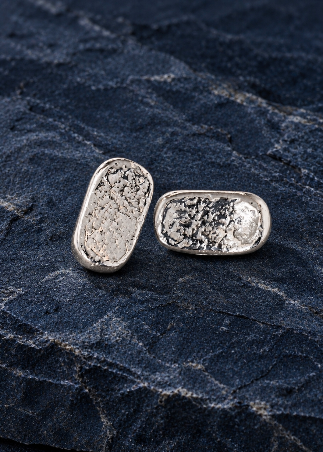 Silver Textured Oblong Earrings on deep navy stone