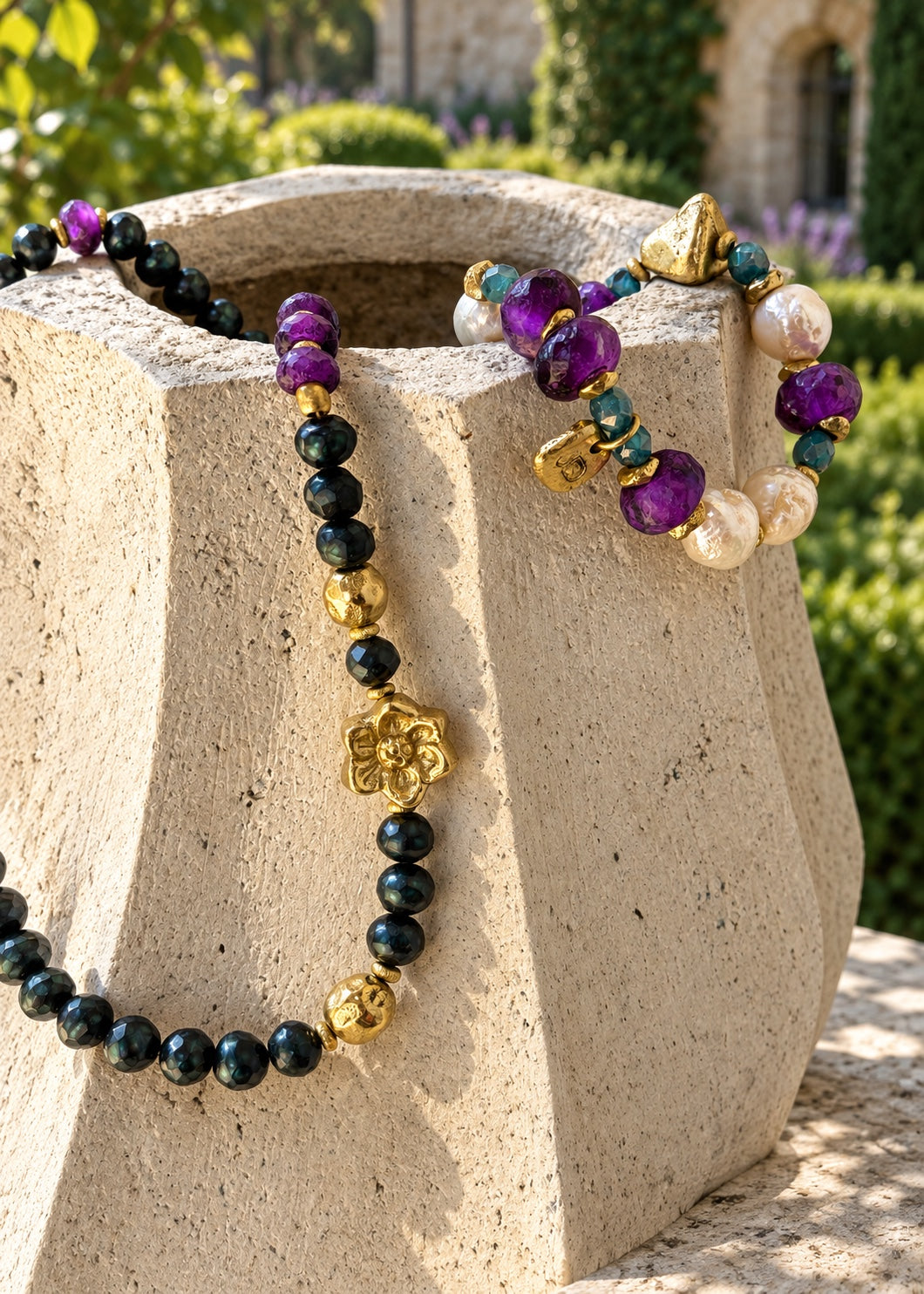 Where Magnolias Grow necklace on stone planter; bracelet sold separately